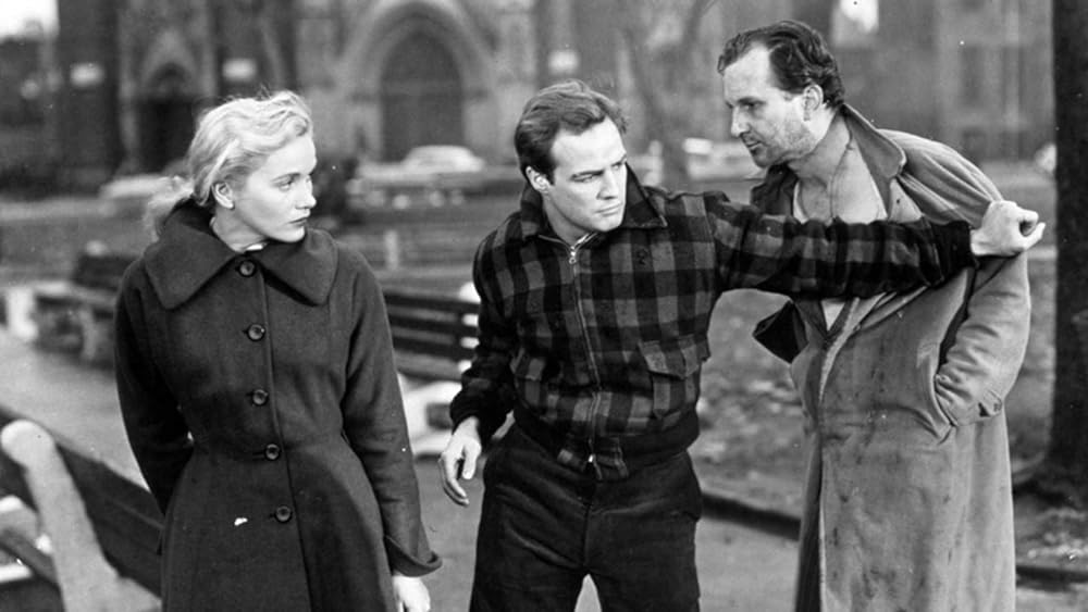 A screenshot of On the Waterfront (1954) with Marlon Brando pushing a guy away.