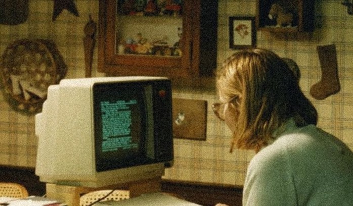 A person in front of a 80s computer.